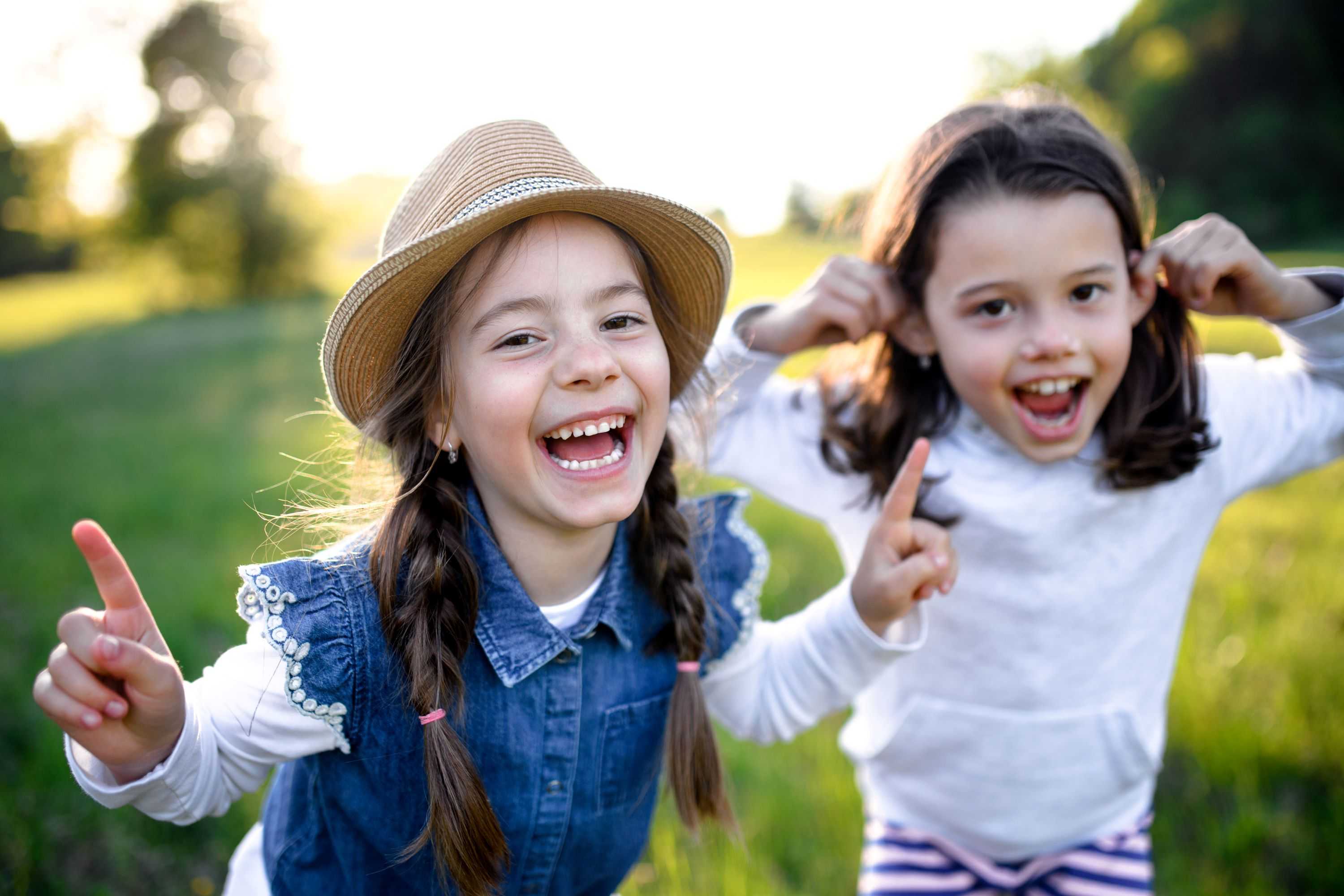 two little girls hugging and laughing